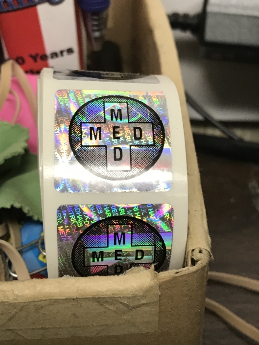 In working with our client “Seeds for Deeds” we made these special flashy stock square labels with the medical cross on them. This highlights how through using dithered print you can actually almost achieve another 3-D effect with your over printing.