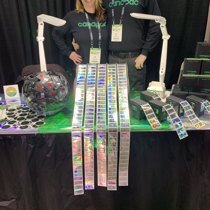 Boston NCIA show 2019 company owner Lisa Sedita and her husband Scott graphic designer working the booth at the NCIA show in Boston Massachusetts 2019. At that time and now, still leading the industry as one of the only suppliers of cannabis specific tamper evident custom-made holograms.